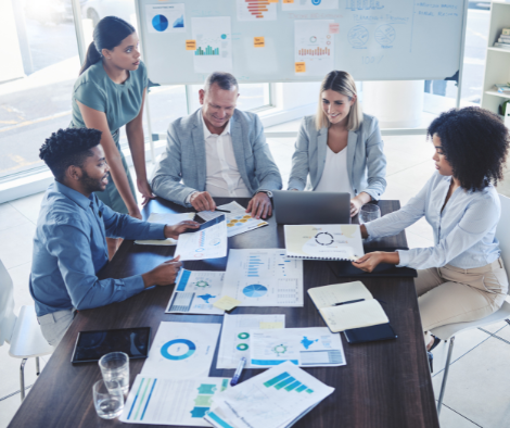 Image of a team working together and discussing statistics and other materials.