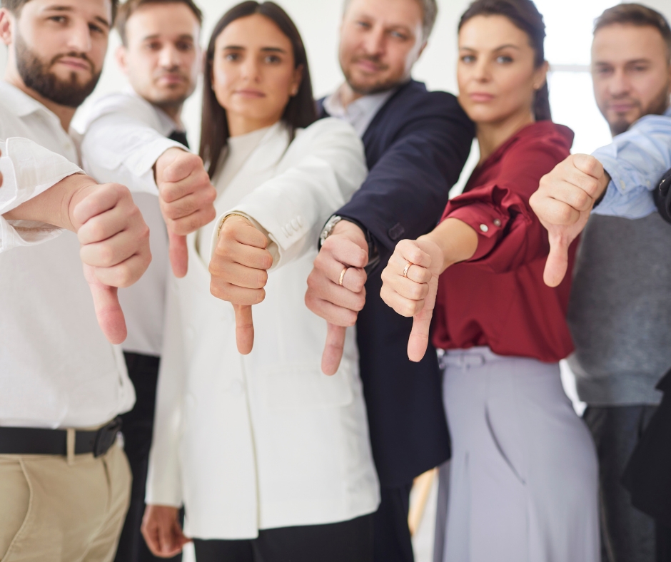 image of a group of people giving thumbs down, signifying bad reviews
