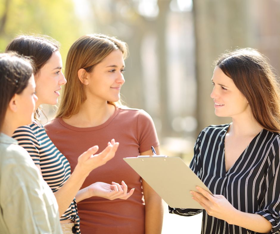 picture of someone doing a survey with 3 people